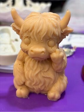 Resin highland cow giving the finger